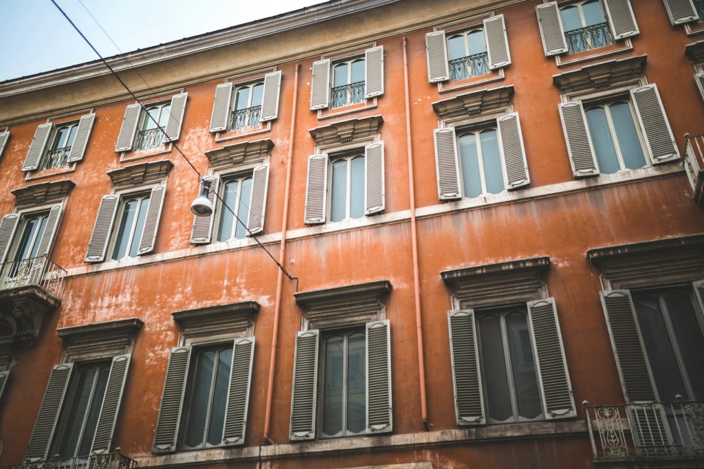 Red building facade in historical quarter of Rome
