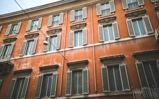 Red building facade in historical quarter of Rome